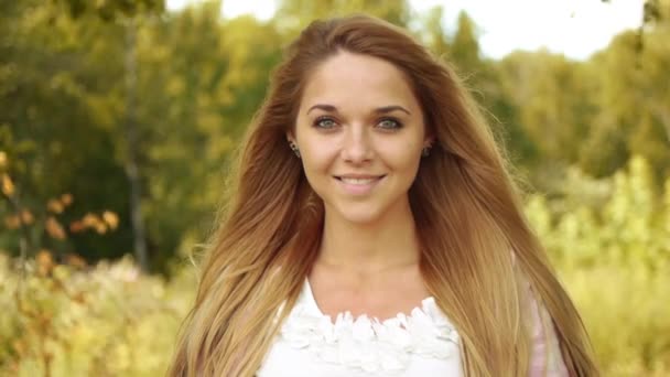 Close-up van langharige, vrolijke vrouw is het lezen van goede boeken op achtergrond van zomer park — Stockvideo