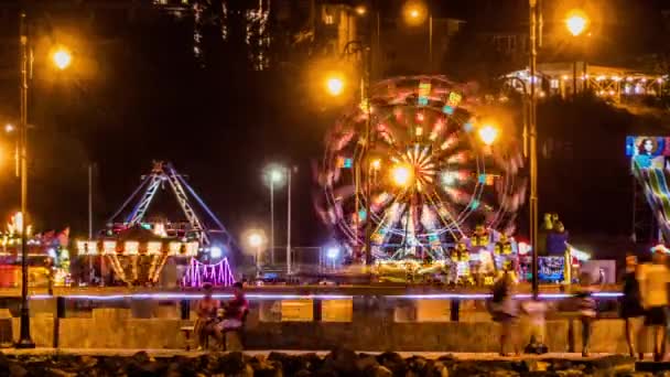 NESSEBAR, BULGARIA - JULY 26 2016: Timelapse night attractions and entertainment, a Ferris wheel. Nesebar is an ancient town and one of the major seaside resorts on the Bulgarian Black Sea Coast. — Stock Video