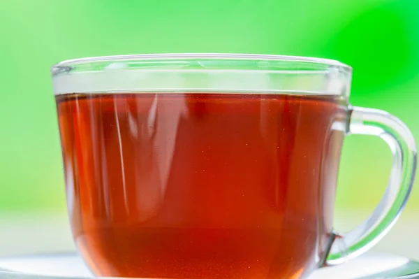 Glass Transparent Cup Black Tea Saucer Green Background — Stock Photo, Image