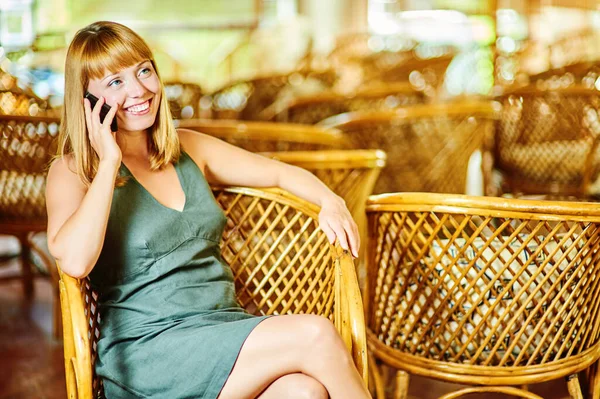 Young Beautiful Woman Green Dress Sitting Wooden Wicker Chair Talking — Stock Photo, Image