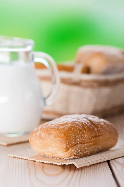 Wooden Table Pone Bun Pitcher Milk Green Background — Stock Photo, Image