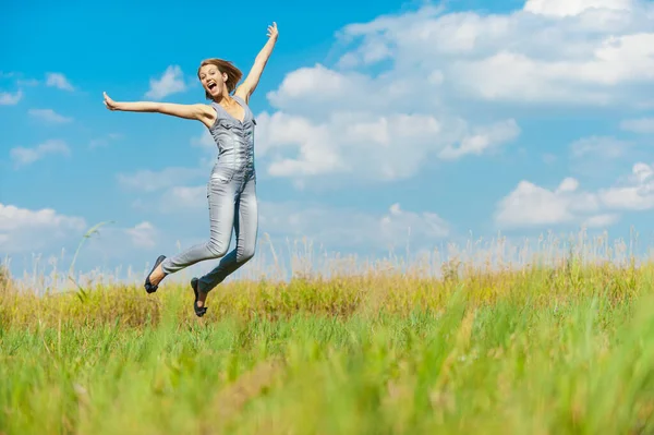 Young Beautiful Woman Blue Denim Overalls Fun Jumps Blue Sky — Stock Photo, Image