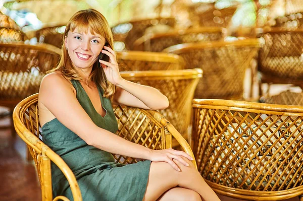 Young Beautiful Woman Green Dress Sitting Wooden Wicker Chair Talking — Stock Photo, Image