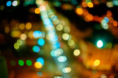 Odaklanamayan Bokeh ışıkları gece bir yolda trafik sıkışıklığı yaratıyor. Yol trafiği bulanık odak.