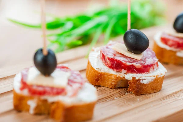 Sausage Sandwiches Cheese Olives Toothpick Wooden Table Background — Stock Photo, Image