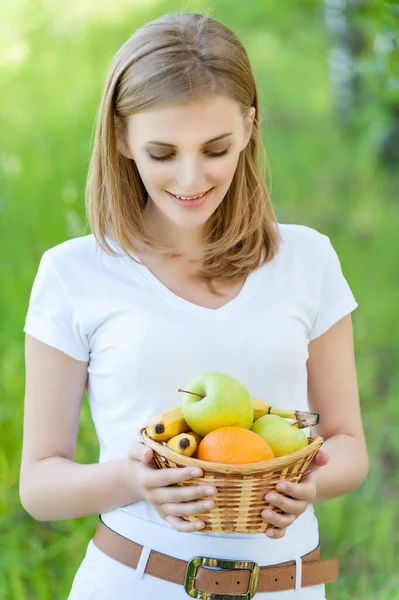 Young Pretty Smiling Woman White Blouse Holds Basket Fruit Background — Stock Photo, Image