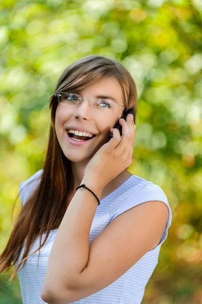 Genç Güzel Gülen Bir Kadın Gözlüklü Uzun Saçlı Cep Telefonuyla — Stok fotoğraf