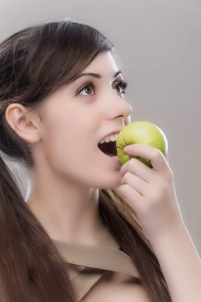 Young Pretty Woman Dark Long Hair Takes Bite Green Apple — Stock Photo, Image