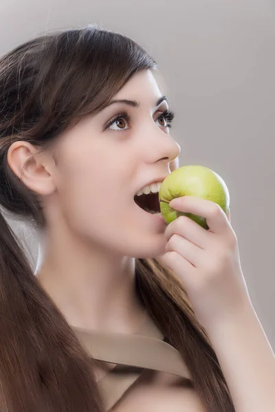 Koyu Renk Uzun Saçlı Güzel Bir Kadın Yeşil Bir Elmadan — Stok fotoğraf