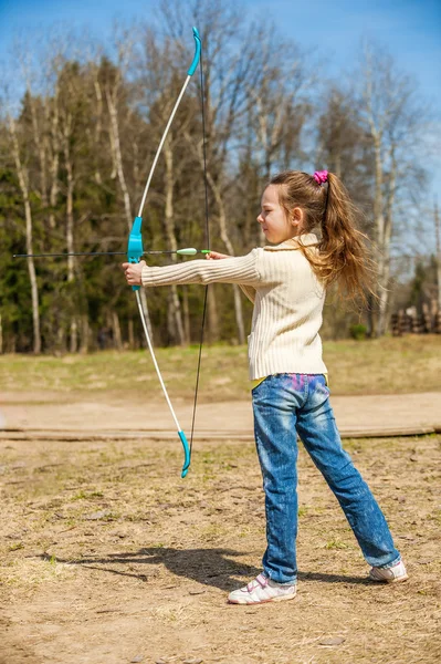 little girl shoots bow
