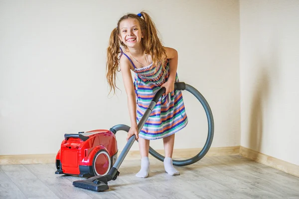 Smiling girl with vacuum cleaner — Stock Photo, Image