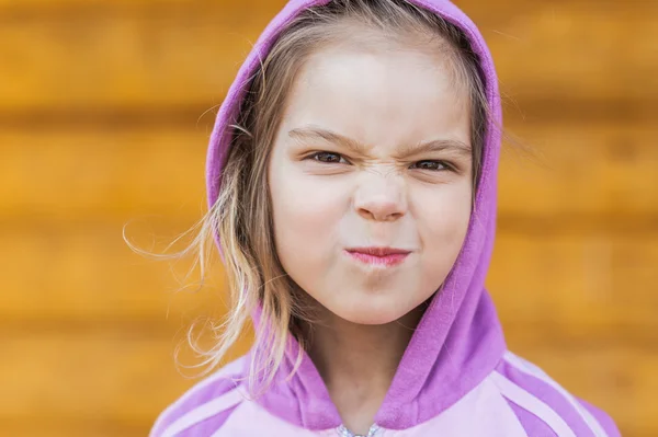 Little girl hamming builds grimaces — Stock Photo, Image