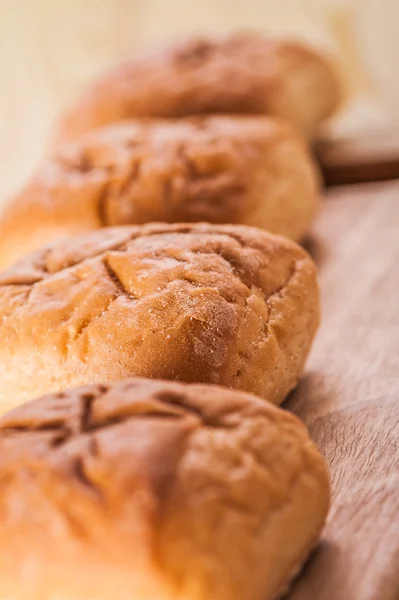 Rolls on wooden background — Stock Photo, Image