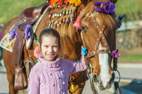 Little girl with festive horse — Stock Photo, Image