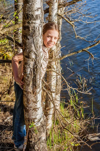 Little girl hides among birch trees — Stock Photo, Image