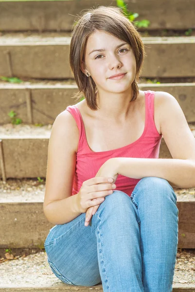 Young girl sits on steps — Stock Photo, Image