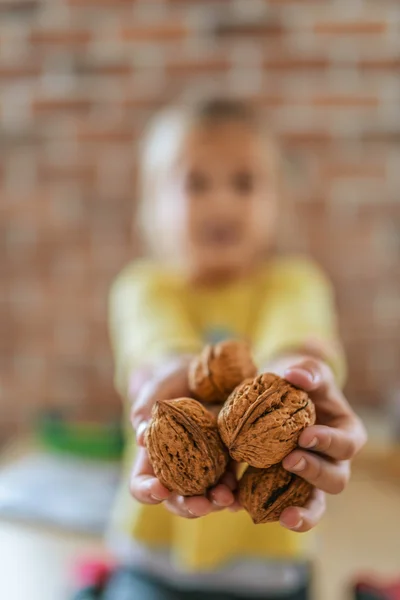 Little girl with walnuts — Stock Photo, Image
