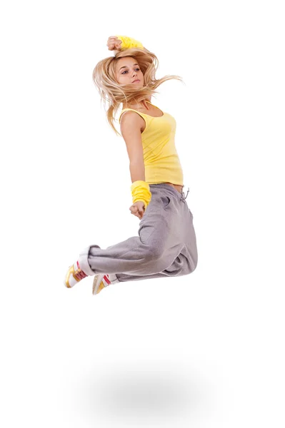 跳跃的黄色衣服的年轻女子 — 图库照片