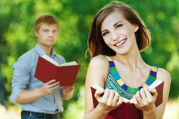 Two students with book — Stock Photo, Image