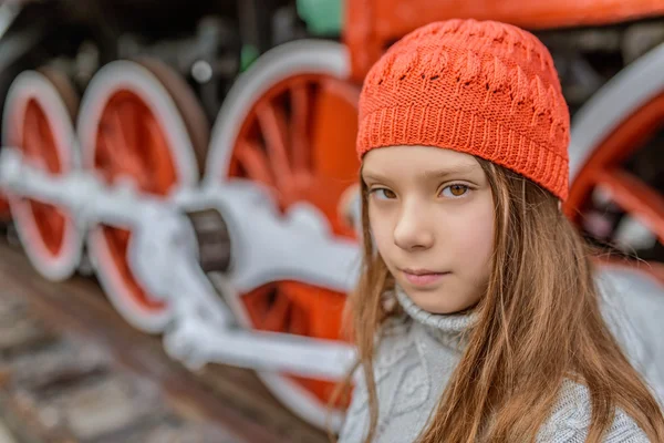 Klein meisje in de buurt van de oude stoomlocomotief — Stockfoto