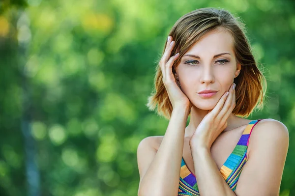 Young woman in color dress thought — Stock Photo, Image