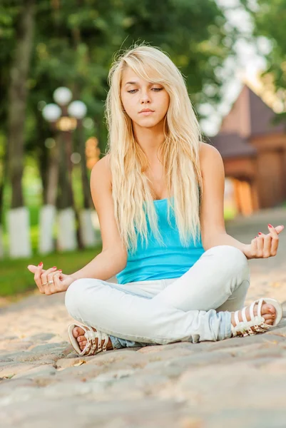 Girl in lotus pose — Stock Photo, Image