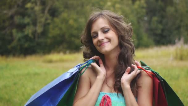 Portrait pretty young woman shopping bags — Stock Video