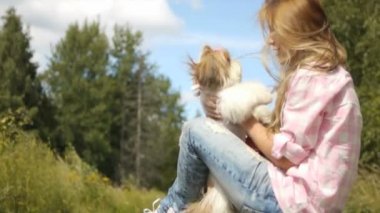 young woman holds dog her arms