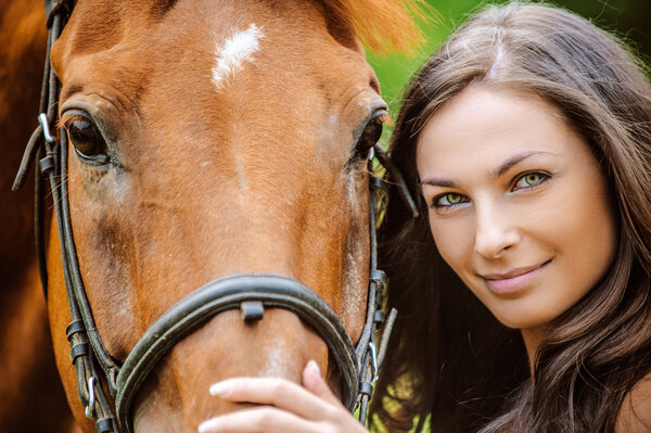 portrait of young smiling woman with horse