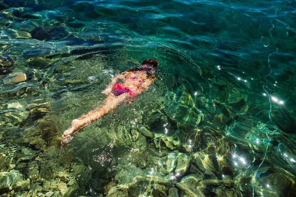 Menina flutuando no mar — Fotografia de Stock