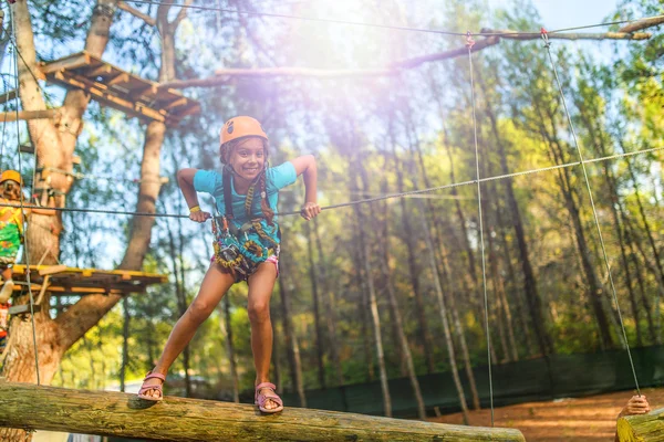 Flicka klättring i äventyrsparken — Stockfoto