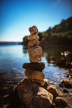 Cairn on shore of Sea clipart