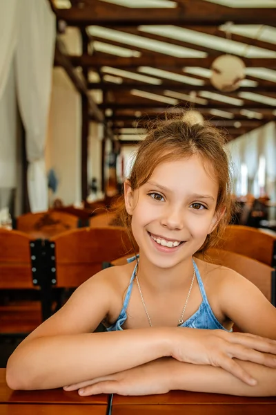 Little beautiful cheerful girl in restaurant — Stock Photo, Image