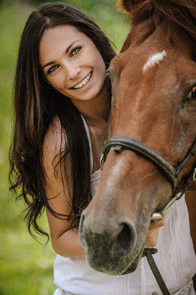 portrait of young smiling woman with horse