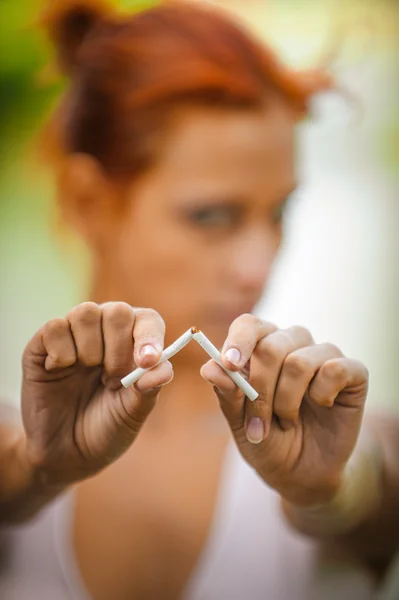 Beautiful woman breaking cigarette — Stock Photo, Image