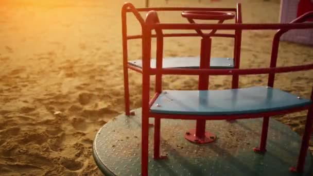 Childrens carousel in the playground in the autumn park. — Stock Video