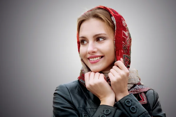 Young beautiful woman in a red scarf — Stock Photo, Image