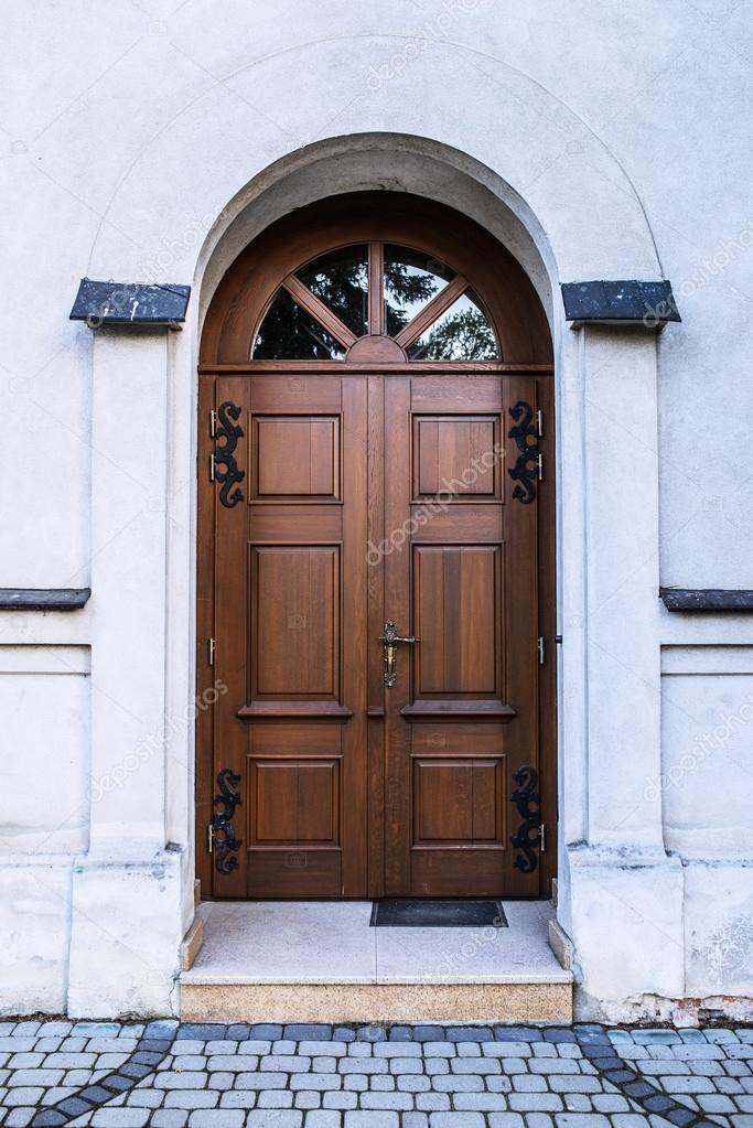 Old wooden door with glass in ancient building