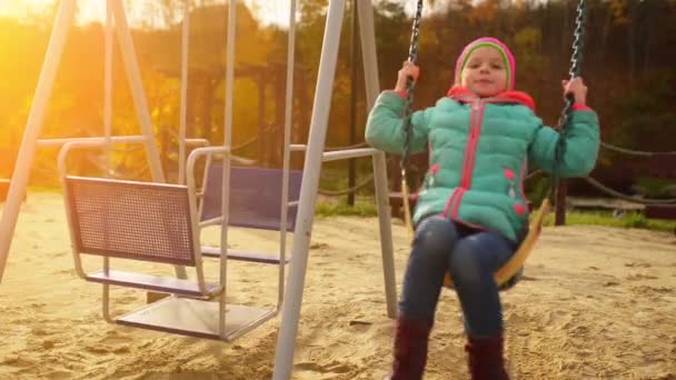 Vacker liten flicka på svingen — Stockvideo