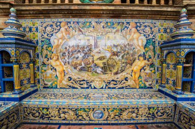 SEVILLE, SPAIN - 07 Nisan 2019: İspanya 'nın büyük bir turizm merkezi olan Seville' deki Plaza de Espana 'nın duvarları boyunca uzanan fayanslı taşra oyuğu