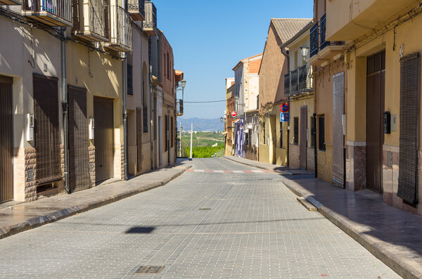 Street with colourful houses in little mountain village, province of Alicante, Spain