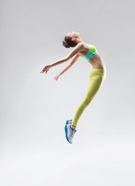 Jumping girl in studio — Stock Photo, Image