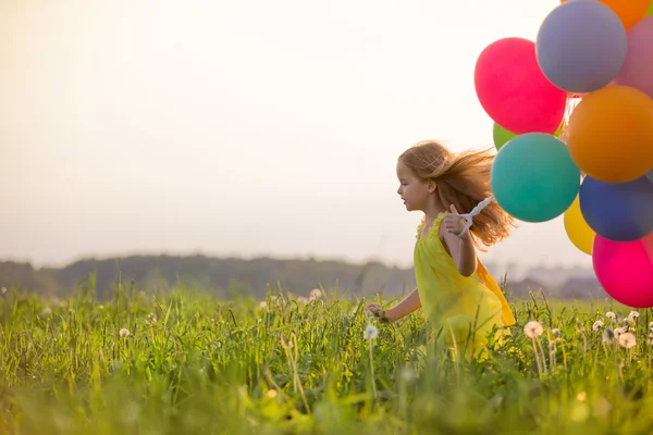 Liten flicka med ballonger — Stockfoto