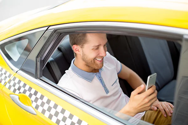 Young man in a taxi — Stock Photo, Image