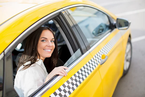 Mulher sorridente em um táxi — Fotografia de Stock