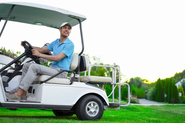 Young golfer on cart — Stock Photo, Image