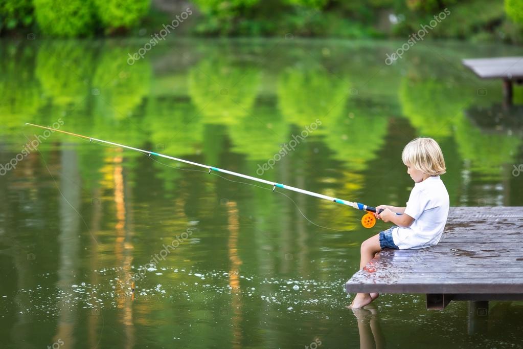 Little boy fishing outdoors — Stock Photo © Deklofenak #111006892