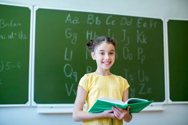 Schoolgirl with book — Stock Photo, Image