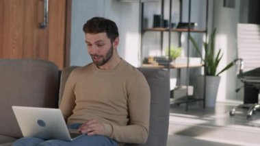 Smiling student receiving good news at home office