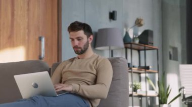 Successfull man emotionally rejoices at good news at home office